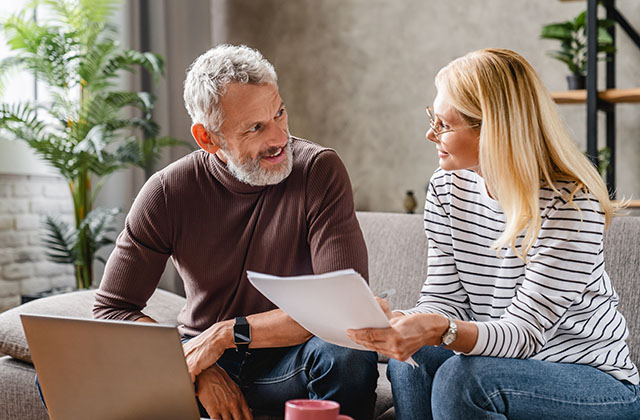 a couple reviewing paperwork for their income tax filing