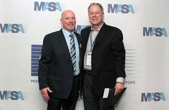 Dr. Aaron Zalis receives the Distinguished Service Award from MASA