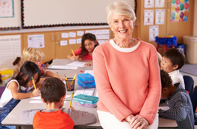retiree volunteering in a classroom with children