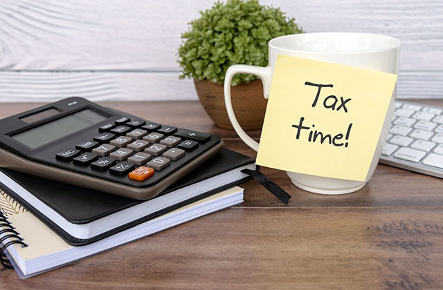 decorative image showing a coffee cup and calculator on desktop