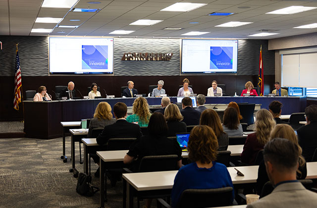 Board trustees and officers discuss business at the April 2026 board meeting