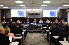 Trustees and officers seated at the board dais for the April 2026 Board Meeting