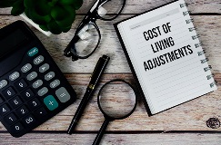decorative image of a calculator, pens, reading glasses and a notebook