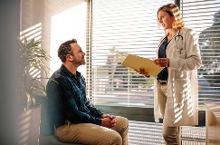 a patient receives news from a doctor in a medical office