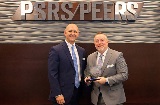 PSRS/PEERS Executive Director Dearld Snider presents an an award to retiring trustee, Dr. Kyle Collins.
