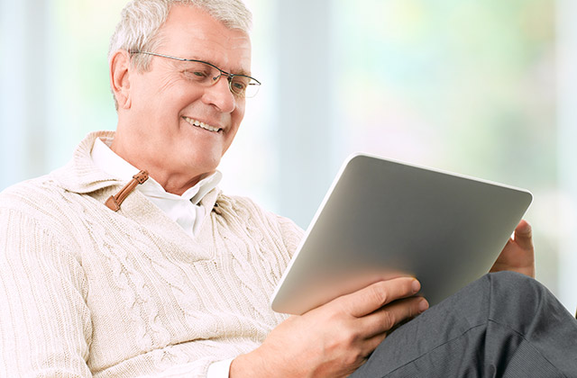 older gentleman viewing content on a tablet device