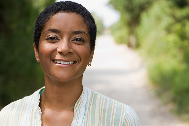 middle-aged woman posing for the camera in an outdoor setting