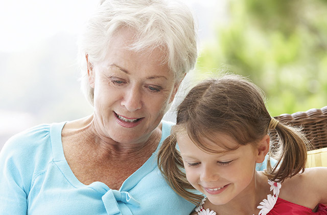 grandmother and granddaughter reading together