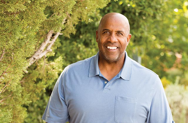 middle aged man outdoors smiling at camera