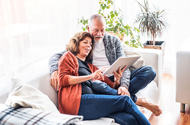 older-couple-on-couch-with-laptop