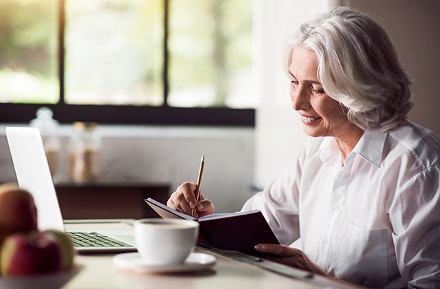 woman writing notes in a notebook