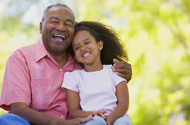 smiling grandfather with grand-daughter