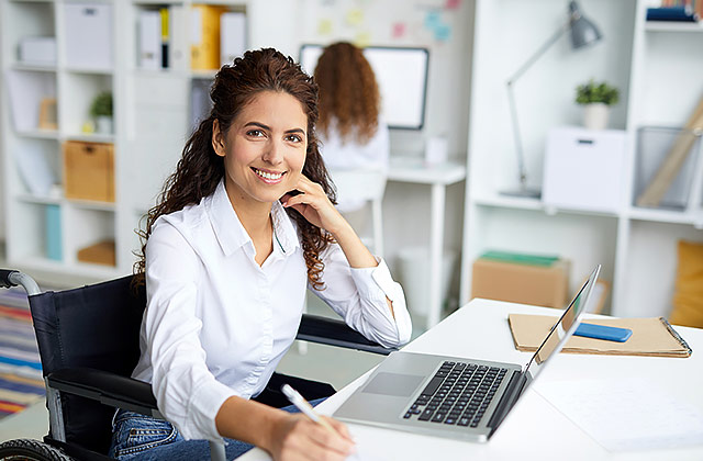 woman at desk with laptop computer